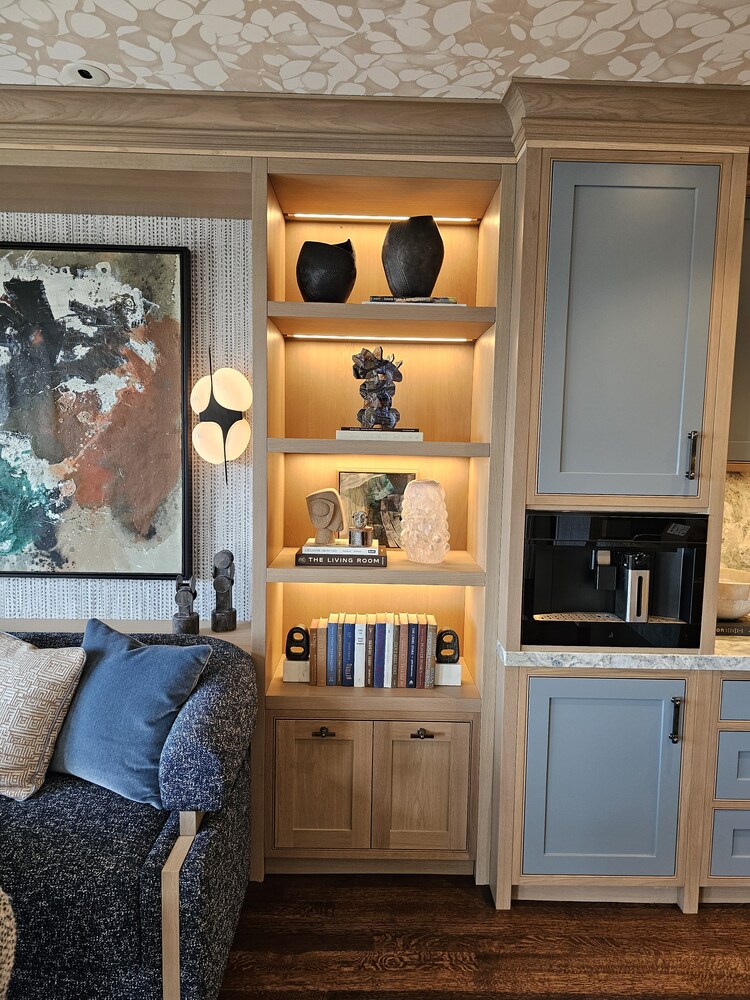 Artistic shelving with warm wood tones and curated decor in Belvedere home by S.A. Baxter, Inc.