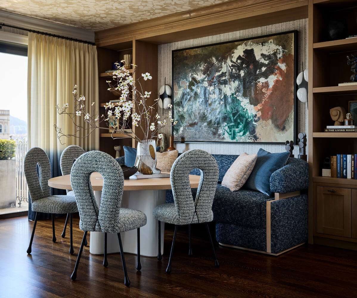 Bright dining nook with round table and upholstered chairs in a Belvedere custom home by S.A. Baxter, Inc.