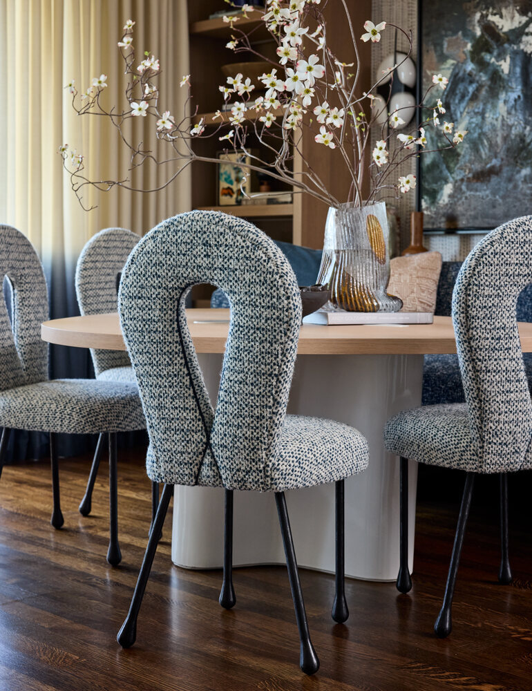 Close-up of boucle dining chairs and centerpiece florals in an Atherton custom home by S.A. Baxter, Inc.