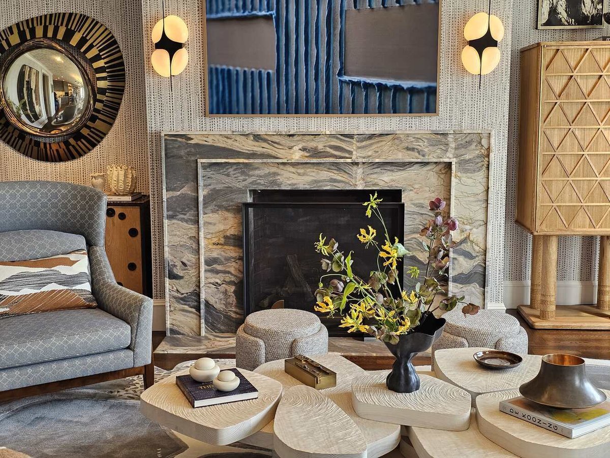 Detailed view of marble fireplace and centerpiece floral arrangement in Tiburon by S.A. Baxter, Inc.