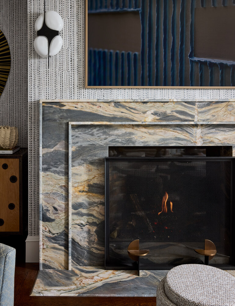 Elegant marble fireplace with a modern art piece in a Sausalito custom home by S.A. Baxter, Inc.