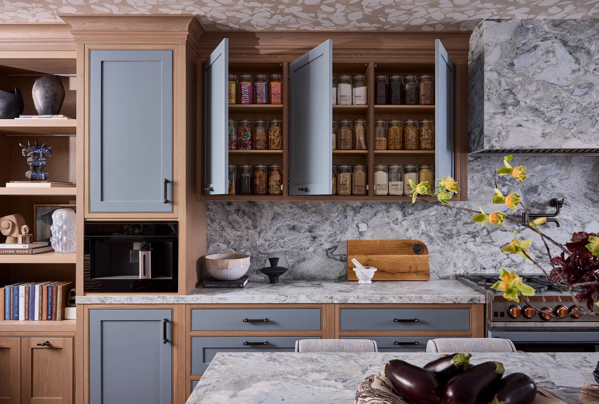 Elevated kitchen pantry reveal with stone counters and wood cabinetry in Tiburon custom home by S.A. Baxter, Inc.