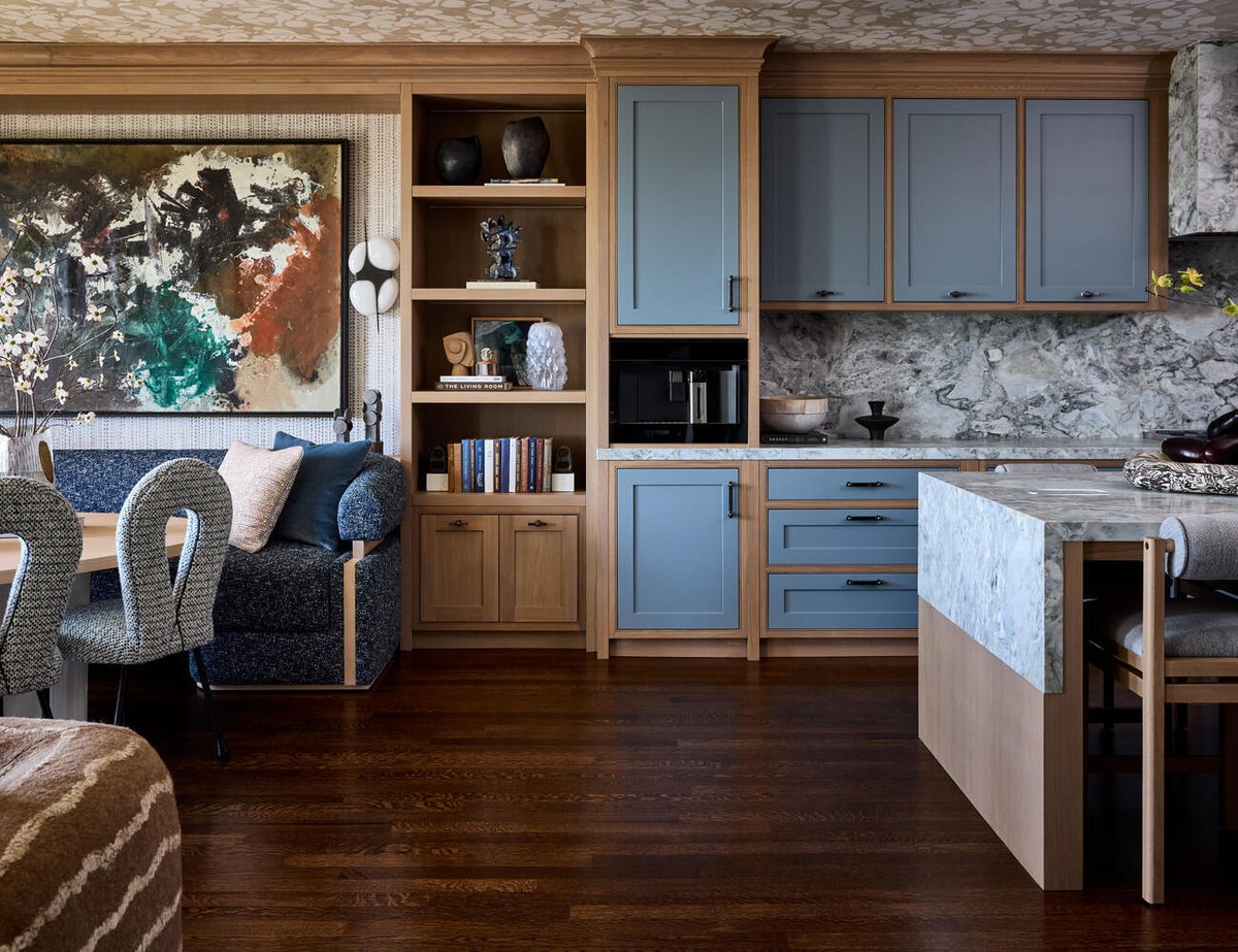 View of designer kitchen with blue cabinetry and art-forward shelving in Mill Valley custom home by S.A. Baxter, Inc.
