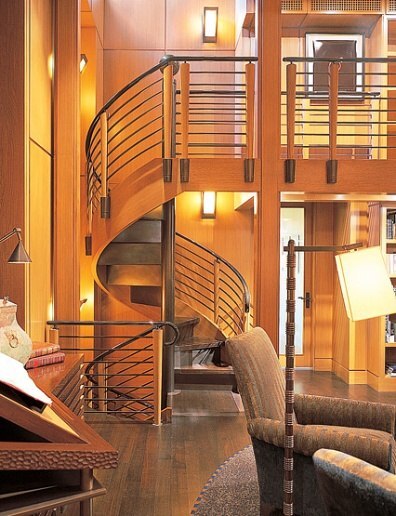 Contemporary reading nook in circular library with spiral staircase by S.A. Baxter, Inc. in Carmel Highlands, CA.