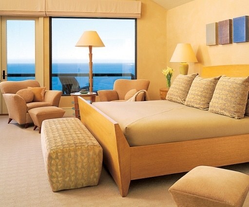 Ocean-view bedroom with custom furnishings and neutral tones by S.A. Baxter, Inc. in Carmel Highlands, CA.