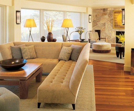 Sophisticated living room with wraparound windows and custom stone fireplace by S.A. Baxter, Inc. in Carmel Highlands, CA.