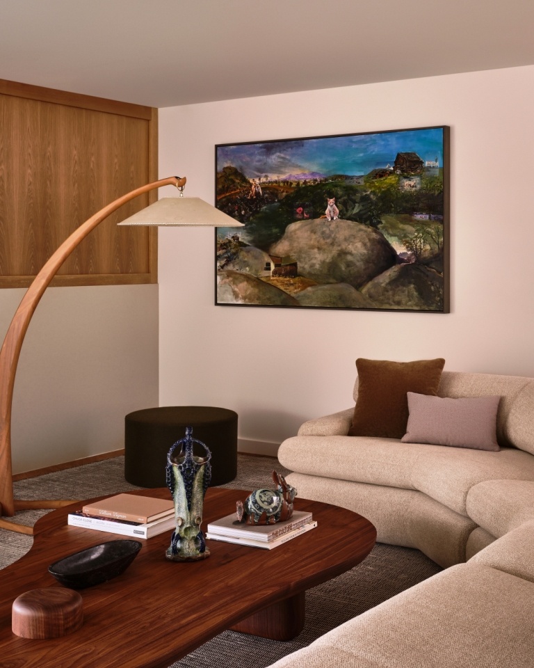Cozy living room corner with curved sectional and sculptural wooden lamp in a Marin County home by S.A. Baxter, Inc.