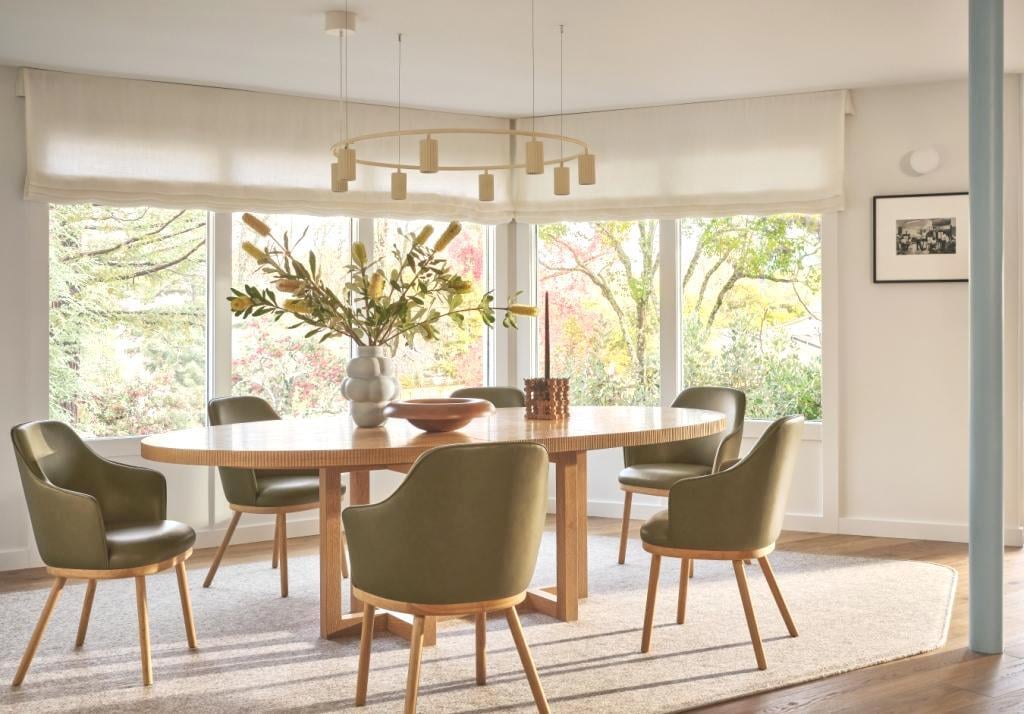 Dining area with round wood table and green chairs in a custom home by S.A. Baxter, Inc., Marin County, CA