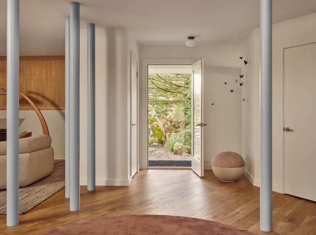 Entryway with blue accent columns and open door to garden in a Marin County custom home by S.A. Baxter, Inc.