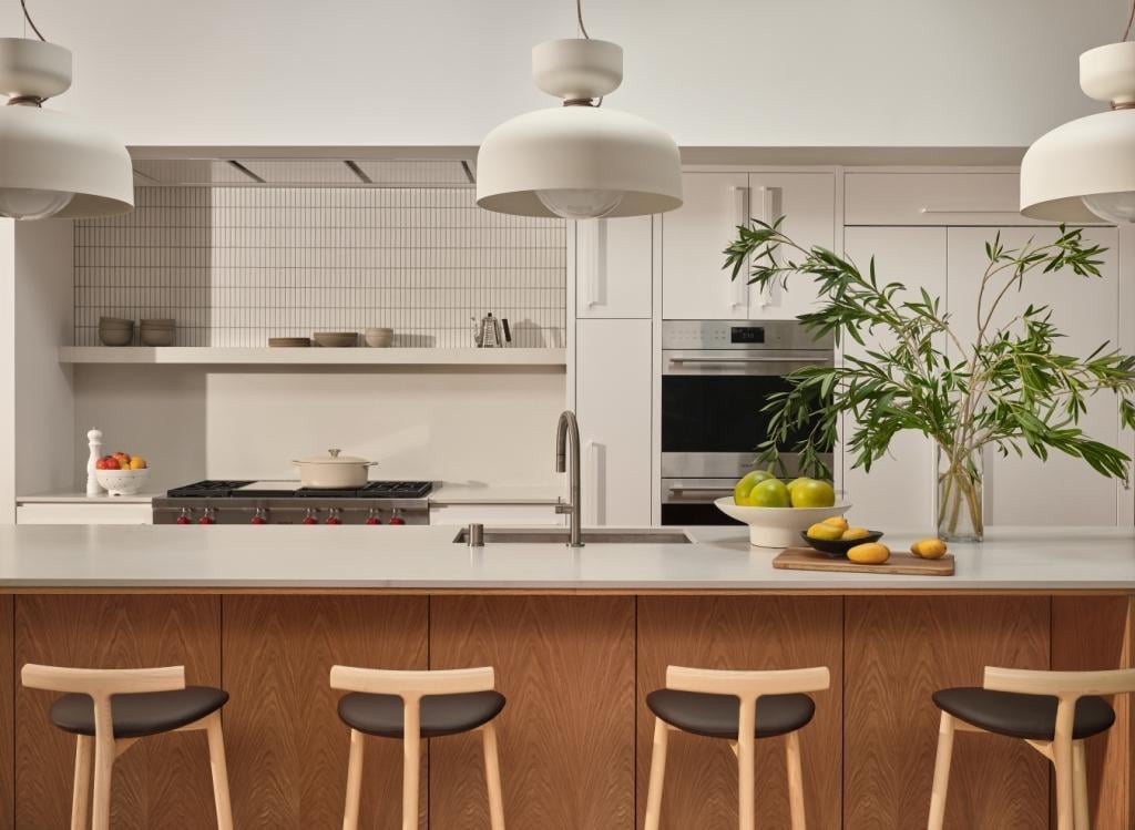 Open kitchen with wood island, pendant lights, and modern appliances by S.A. Baxter, Inc. in Marin County custom home