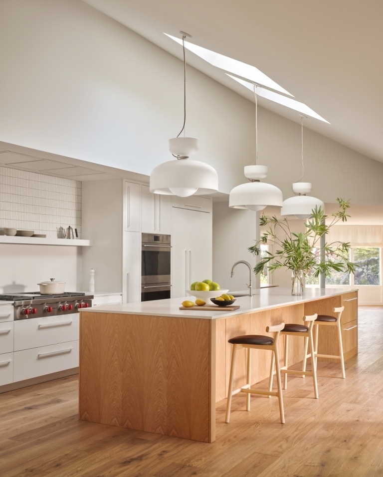 Open-concept kitchen with white countertops and pendant lights by S.A. Baxter, Inc. in Marin County, CA