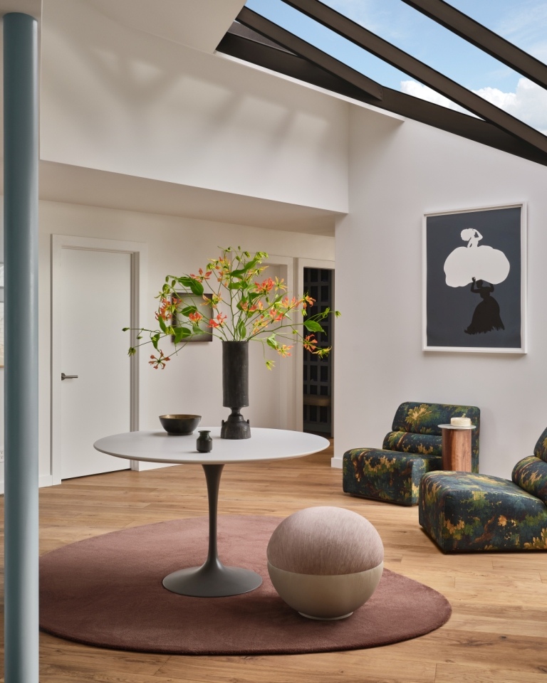 Round white table with floral centerpiece under skylight in custom home by S.A. Baxter, Inc., Marin County, CA