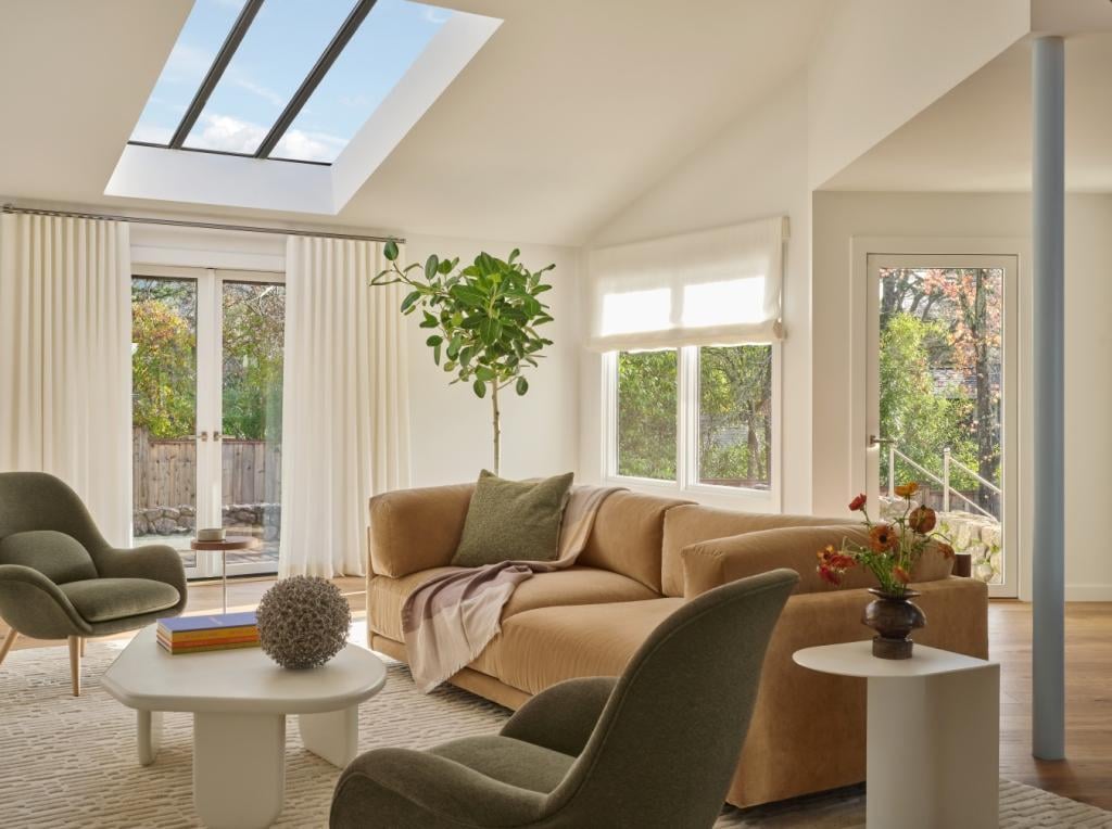Sunlit seating area with tan sectional and modern lounge chairs in a custom Marin County home by S.A. Baxter, Inc.