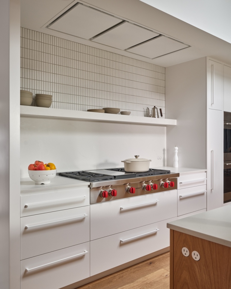 White and wood kitchen with minimalist backsplash in a Marin County custom home by S.A. Baxter, Inc.