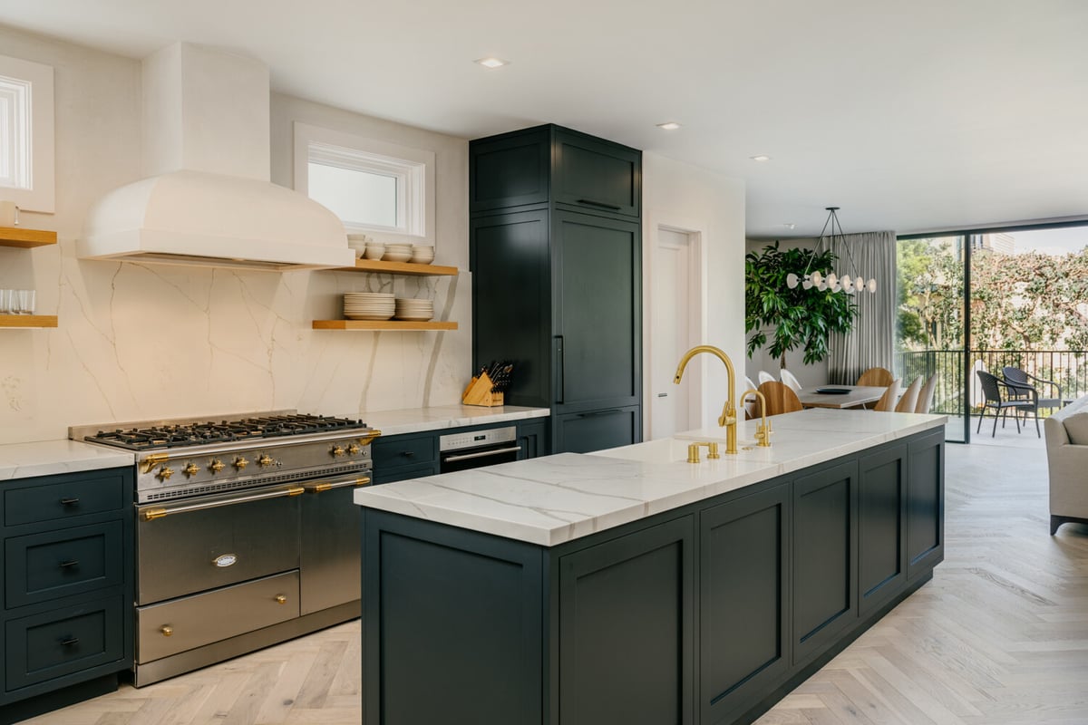 Designer kitchen with marble island and dark cabinetry by S.A. Baxter, Inc. in Marina District custom home