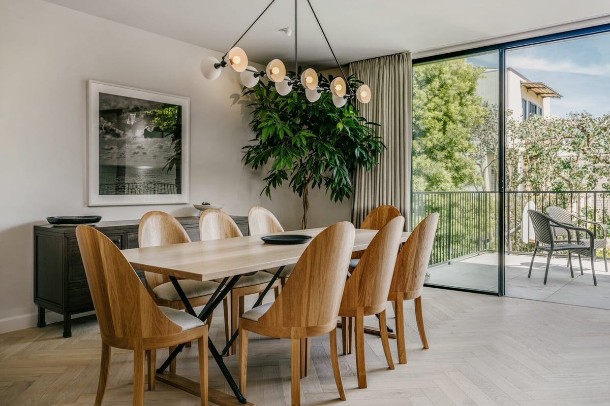 Dining room with wood table and sculptural chandelier in Marina District custom home by S.A. Baxter, Inc.