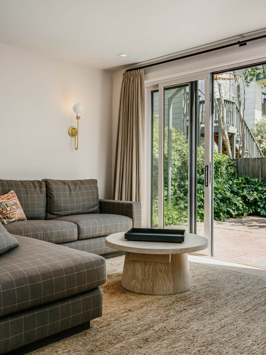 Living room with checkered sofa and garden-facing sliding doors in Marina District custom home by S.A. Baxter, Inc.