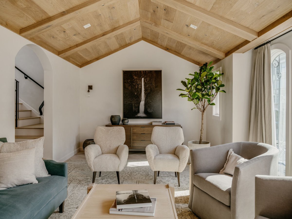 Living room with greenery, soft textiles, and relaxed ambiance by S.A. Baxter, Inc., Marina District, CA