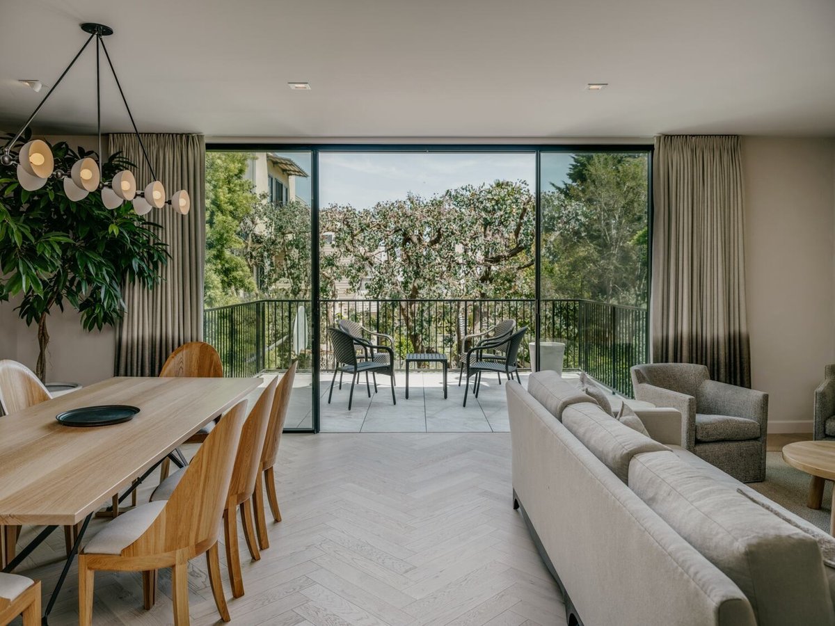 Open concept dining and living room with terrace view by S.A. Baxter, Inc. in Marina District custom home