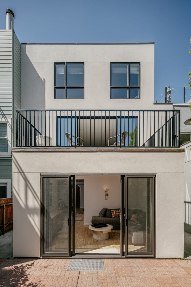 Rear exterior view of modern stucco custom home with balcony by S.A. Baxter, Inc. in the Marina District, CA
