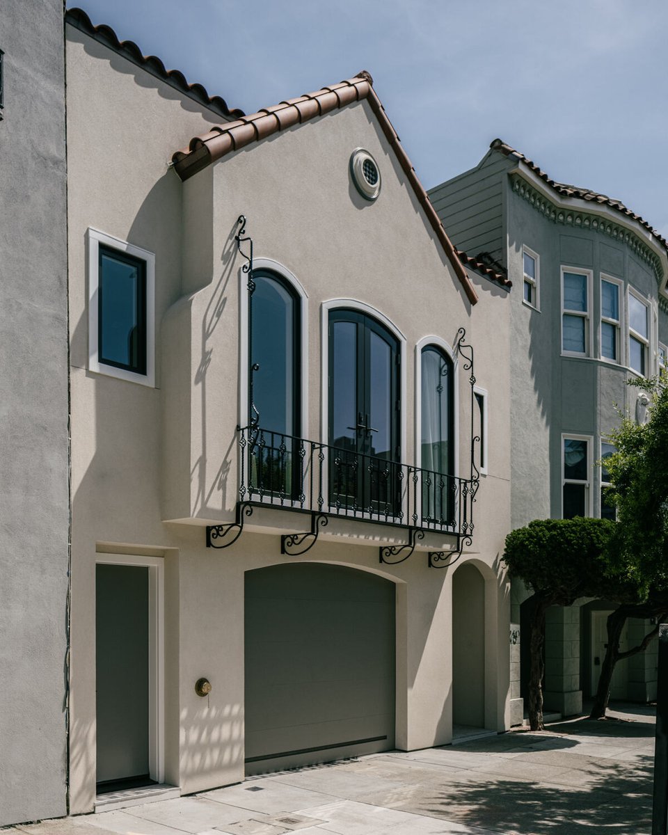 Spanish-inspired custom home facade with wrought iron balcony by S.A. Baxter, Inc. in the Marina District, CA