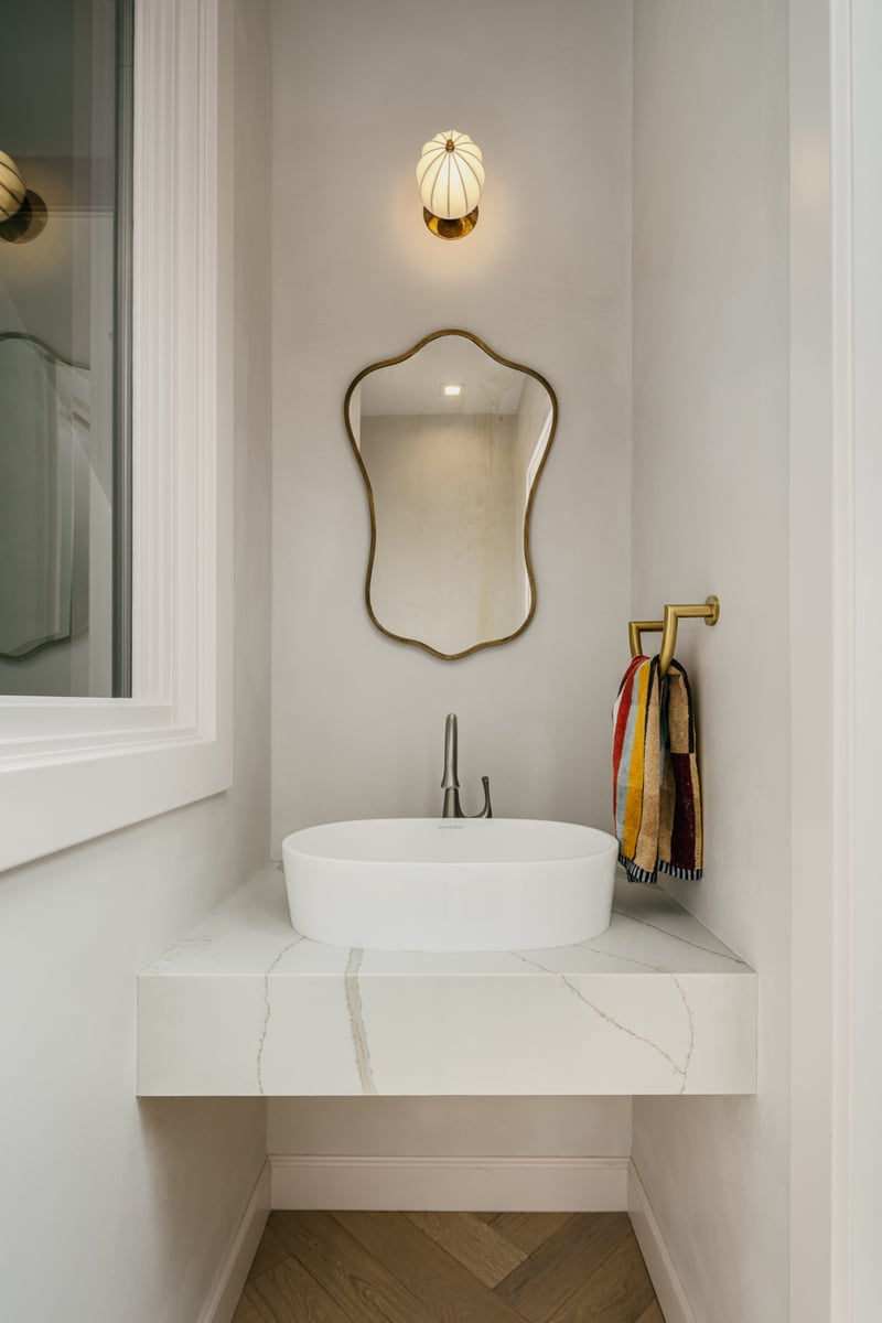 Stylish powder bath with sculptural lighting and vessel sink in custom home by S.A. Baxter, Inc. in the Marina District