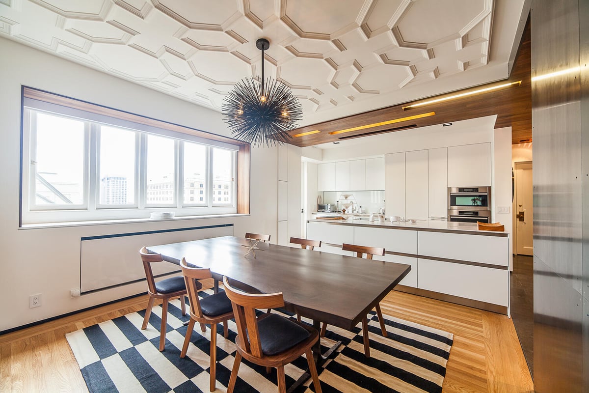 Dining and kitchen area with coffered ceiling and statement chandelier in Nob Hill home by S.A. Baxter, Inc.