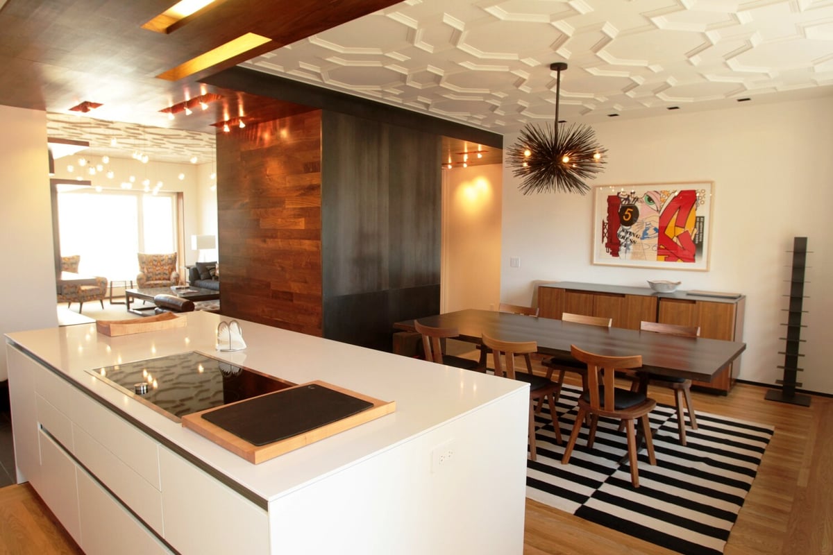 Full view of kitchen island and dining space with wood and black accents in Nob Hill custom home by S.A. Baxter, Inc.