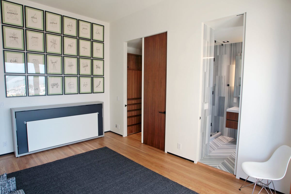 Gallery-style art arrangement with closet and bathroom access in Nob Hill, CA home by S.A. Baxter, Inc.
