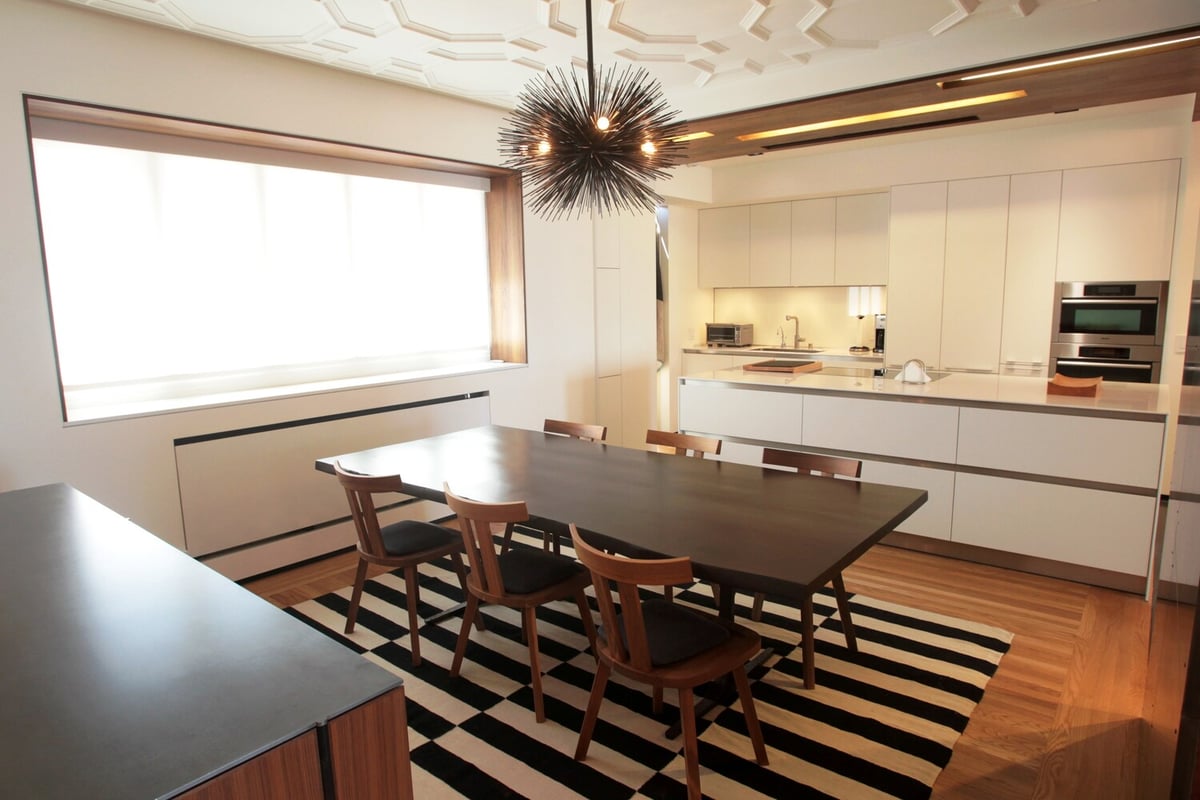 Minimalist kitchen with sculptural ceiling and central dining table in custom Nob Hill home by S.A. Baxter, Inc.