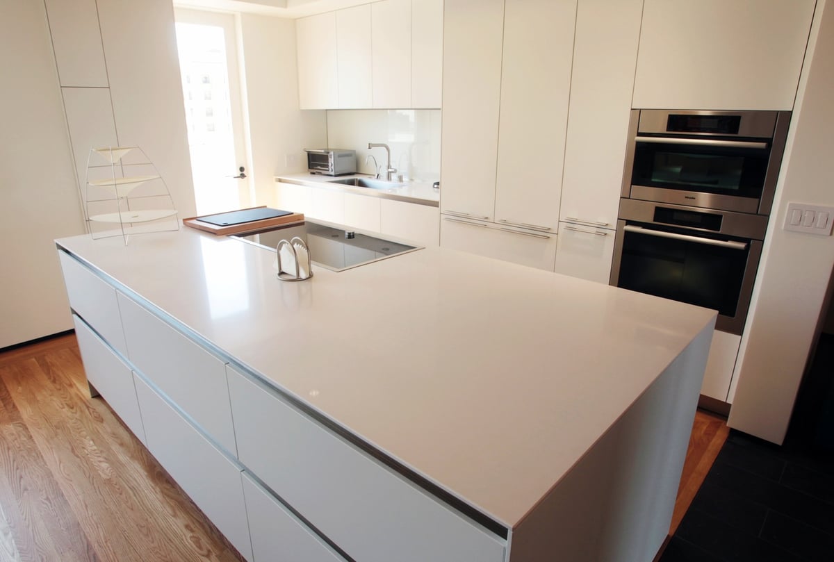 Minimalist white kitchen with modern island in custom Nob Hill home by S.A. Baxter, Inc.