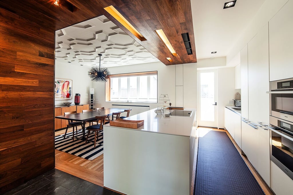 Sunlit kitchen with large island and custom cabinetry in Nob Hill custom home by S.A. Baxter, Inc.