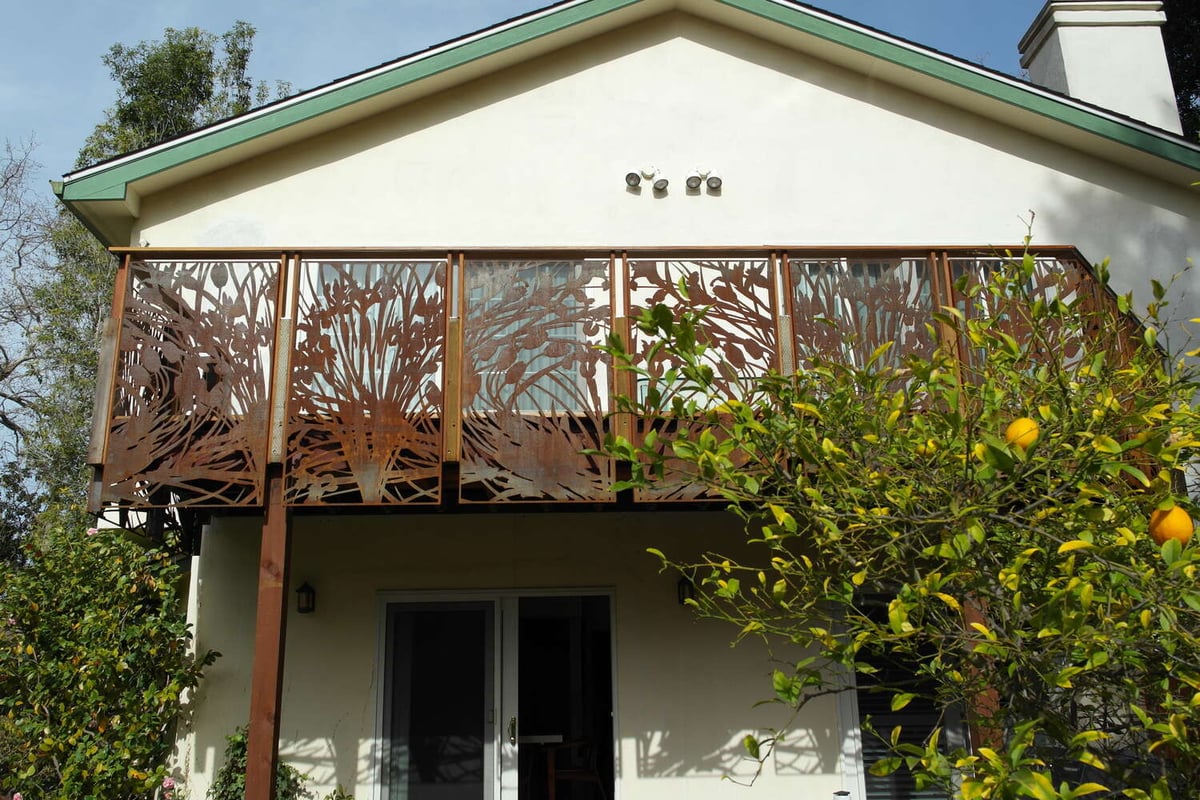 Front view of custom home balcony with decorative rusted metal railing in Palo Alto, CA by S.A. Baxter, Inc.