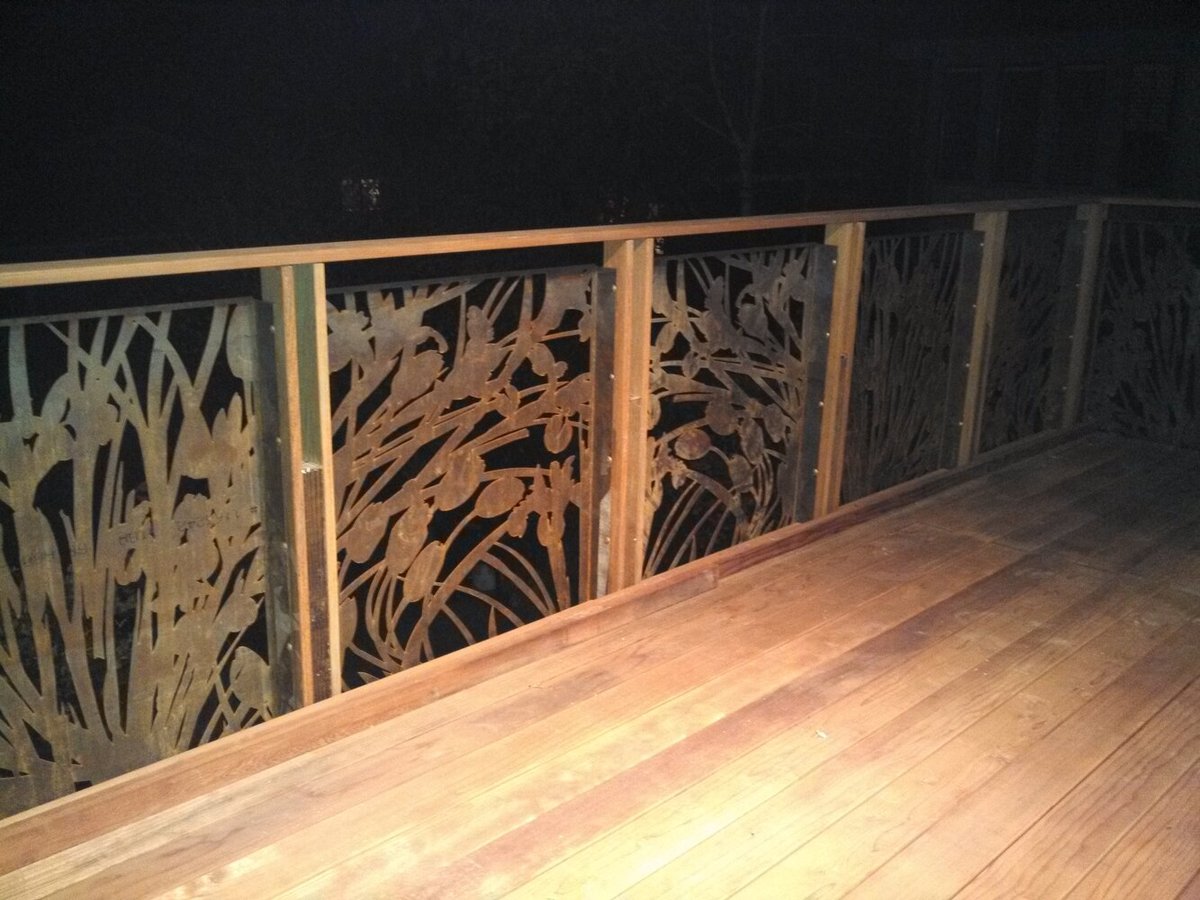 Nighttime view of decorative balcony railing with botanical cutout design by S.A. Baxter, Inc., Palo Alto.