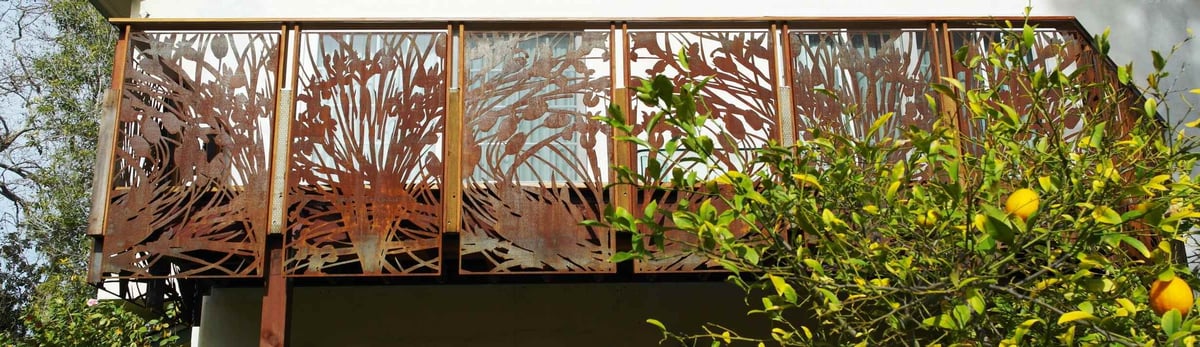 Wide-angle view of custom balcony railing with nature motifs in Palo Alto home by S.A. Baxter, Inc.