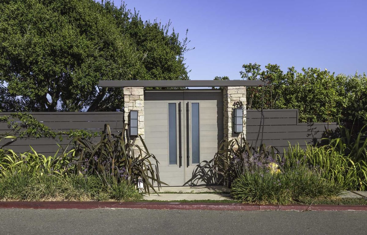 Custom-designed front gate with stone pillars and modern wood fencing in Tiburon by S.A. Baxter, Inc.