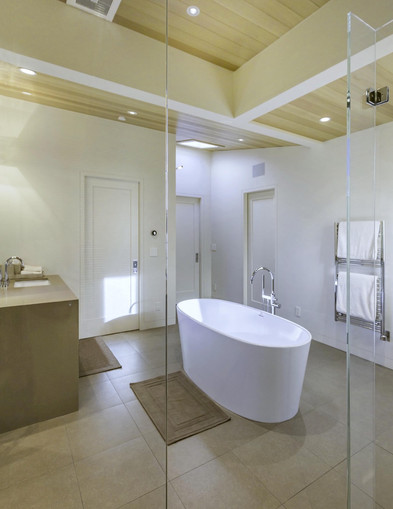 Freestanding soaking tub centered in minimalist master bath in Tiburon home by S.A. Baxter, Inc.