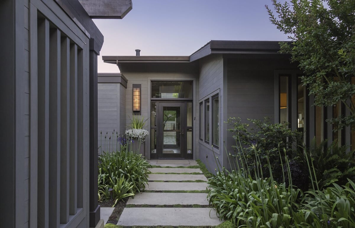 Modern entry path with concrete pavers and lush landscaping in Tiburon custom home by S.A. Baxter, Inc.